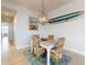 Coastal dining area featuring a wooden table, wicker chairs, and a surfboard wall decoration at 5 Riverwalk Dr # 601, New Smyrna Beach, FL 32169