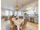 Open floor plan with a dining table and wicker chairs, connecting to the kitchen and living room at 5 Riverwalk Dr # 601, New Smyrna Beach, FL 32169