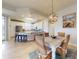 Cozy dining area beside the kitchen with wicker chairs, a wooden table, and a decorative light fixture at 5 Riverwalk Dr # 601, New Smyrna Beach, FL 32169