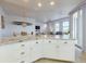 Open concept kitchen with white cabinets, stainless steel appliances, granite countertops and water views at 5 Riverwalk Dr # 601, New Smyrna Beach, FL 32169