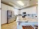 Bright kitchen featuring stainless steel appliances, a granite countertop island, and white cabinetry at 5 Riverwalk Dr # 601, New Smyrna Beach, FL 32169