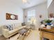 Cozy living room with a comfortable couch, striped ottomans, and stylish decor at 5 Riverwalk Dr # 601, New Smyrna Beach, FL 32169
