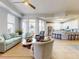 Open living space showcasing tile floors, a ceiling fan, comfortable seating, and access to the kitchen and dining area at 5 Riverwalk Dr # 601, New Smyrna Beach, FL 32169