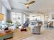 Open-concept living room with a fan, tile flooring, an adjacent kitchen, and a dining area at 5 Riverwalk Dr # 601, New Smyrna Beach, FL 32169