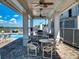 Enjoy this covered poolside patio with tables, chairs, and ceiling fans for outdoor relaxation at 5 Riverwalk Dr # 601, New Smyrna Beach, FL 32169