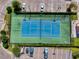 Aerial view of well-maintained tennis courts with neat landscaping and parking at 5 Riverwalk Dr # 601, New Smyrna Beach, FL 32169