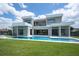 Stunning modern home featuring a sparkling pool, lush lawn, and expansive patio perfect for outdoor entertaining at 5023 Sawyer Cove Way, Windermere, FL 34786