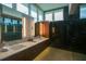 Modern bathroom featuring double sinks, a large mirror, and a sleek, glass-enclosed shower at 5023 Sawyer Cove Way, Windermere, FL 34786