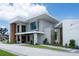Stunning two-story home with modern architecture, lush landscaping, and a paved driveway at 5023 Sawyer Cove Way, Windermere, FL 34786