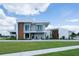 Modern home showcasing clean lines, sleek design, and a well-manicured lawn on a sunny day at 5023 Sawyer Cove Way, Windermere, FL 34786