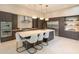 Modern kitchen boasts a large island, stainless steel appliances, and stylish pendant lighting at 5023 Sawyer Cove Way, Windermere, FL 34786