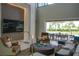 Bright, open living room showcasing modern design with a large TV, stylish decor, and seamless access to the outdoor pool area at 5023 Sawyer Cove Way, Windermere, FL 34786