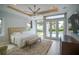 Bright, spacious main bedroom featuring a king-size bed, large windows, and backyard pool access at 5023 Sawyer Cove Way, Windermere, FL 34786