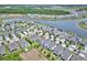 An aerial view showcases the property nestled in a well-maintained neighborhood, complete with lush lawns and scenic surroundings at 5164 Chickadee St, St Cloud, FL 34771