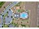 Bird's eye view of community pool, playground, parking, and surrounding area with meticulously landscaped lawns at 5164 Chickadee St, St Cloud, FL 34771