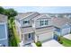 Aerial view of a two-story home featuring a well-maintained lawn and a two-car garage at 5164 Chickadee St, St Cloud, FL 34771