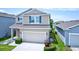 Aerial view of a two-story home with a two-car garage and landscaped front yard at 5164 Chickadee St, St Cloud, FL 34771