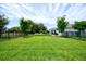 Expansive backyard with lush green grass, fenced perimeter, and beautiful landscaping at 5164 Chickadee St, St Cloud, FL 34771