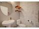 Stylish half bathroom with floating shelves, modern sink, and decorative brick wall at 5164 Chickadee St, St Cloud, FL 34771
