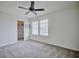 Bright bedroom features neutral carpet, ceiling fan, and a walk-in closet at 5164 Chickadee St, St Cloud, FL 34771