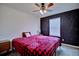 Comfortable bedroom featuring a ceiling fan, a striking wall design, and a window for natural light at 5164 Chickadee St, St Cloud, FL 34771