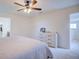 Bedroom featuring neutral walls, a large dresser, and doorways leading to a closet and hallway at 5164 Chickadee St, St Cloud, FL 34771
