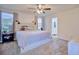 Bright bedroom with windows, neutral walls, ceiling fan and modern decor at 5164 Chickadee St, St Cloud, FL 34771