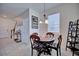 Cozy dining area featuring a round table, chandelier lighting, and neutral tones at 5164 Chickadee St, St Cloud, FL 34771