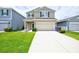 Beautiful two-story home with a spacious driveway, well-kept lawn, and inviting curb appeal at 5164 Chickadee St, St Cloud, FL 34771