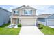 Charming two-story home featuring a two-car garage and well-manicured landscaping at 5164 Chickadee St, St Cloud, FL 34771