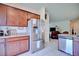 Stylish kitchen with stainless steel appliances, wood cabinets, and granite countertops at 5164 Chickadee St, St Cloud, FL 34771