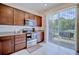 Well-lit kitchen with stainless steel appliances, dark wood cabinetry, and sliding glass doors to patio at 5164 Chickadee St, St Cloud, FL 34771