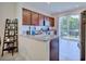 Modern kitchen with granite countertops, stainless steel appliances, and access to the backyard at 5164 Chickadee St, St Cloud, FL 34771