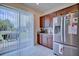 Bright kitchen with stainless steel fridge and sliding glass doors leading to the patio at 5164 Chickadee St, St Cloud, FL 34771