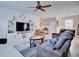 Bright living room with stylish decor, a large television, and views into the dining area at 5164 Chickadee St, St Cloud, FL 34771