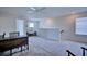 Bright and airy loft area with desk, chair, and a comfortable lounge chair near the window at 5164 Chickadee St, St Cloud, FL 34771