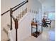 Inviting staircase with dark wood trim, leading to the upper level, next to a console table at 5164 Chickadee St, St Cloud, FL 34771