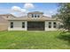 Large, well-maintained backyard featuring lush green grass and the home's rear facade at 5427 Orange Orchard Dr, Winter Garden, FL 34787