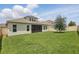 Expansive backyard with lush green grass and a view of the home's screened lanai at 5427 Orange Orchard Dr, Winter Garden, FL 34787