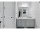 Bright bathroom featuring a double vanity with gray cabinets and quartz countertop at 5427 Orange Orchard Dr, Winter Garden, FL 34787