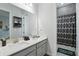 Stylish bathroom featuring a double vanity and decorative patterned shower curtain at 5427 Orange Orchard Dr, Winter Garden, FL 34787