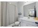 Clean bathroom featuring striped shower curtain, white vanity with plenty of counter space, and a large mirror at 5427 Orange Orchard Dr, Winter Garden, FL 34787