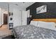 Bedroom featuring a queen size bed, black accent wall and closet with white folding doors at 5427 Orange Orchard Dr, Winter Garden, FL 34787