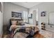 Well-lit bedroom offering louvred windows, sleek wardrobe and a cozy bed with decorative pillows and graphic blanket at 5427 Orange Orchard Dr, Winter Garden, FL 34787