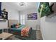 Bright bedroom featuring a TV, unique art, and a comfortable bed with colorful pillows and a patterned throw blanket at 5427 Orange Orchard Dr, Winter Garden, FL 34787