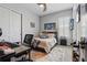 Neat bedroom with desk, louvred windows, dark wardrobe and a comfortable bed with patterned bedding, creating a serene space at 5427 Orange Orchard Dr, Winter Garden, FL 34787