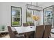 Bright dining area with a stylish light fixture and outdoor views from multiple windows at 5427 Orange Orchard Dr, Winter Garden, FL 34787