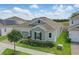 Beautiful home exterior featuring manicured lawn and a two-car garage at 5427 Orange Orchard Dr, Winter Garden, FL 34787