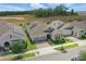 Aerial view featuring the home's exterior with a brick driveway, two-car garage and well maintained lawn at 5427 Orange Orchard Dr, Winter Garden, FL 34787