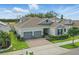 Beautiful home exterior featuring a brick driveway, two-car garage and well maintained lawn at 5427 Orange Orchard Dr, Winter Garden, FL 34787